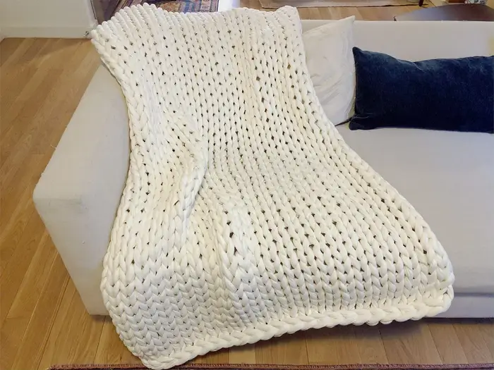 Bearaby cotton napper on bed for stress relief